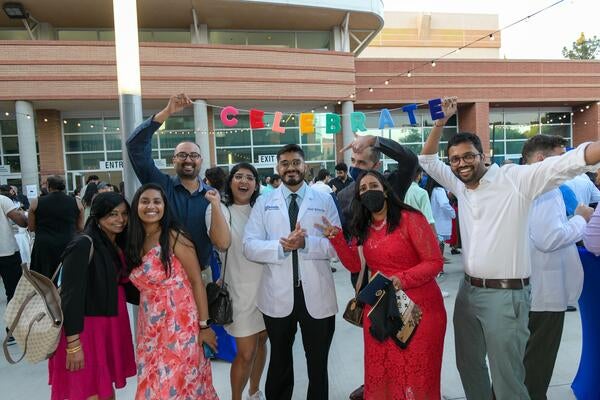 Family celebrating at white coat